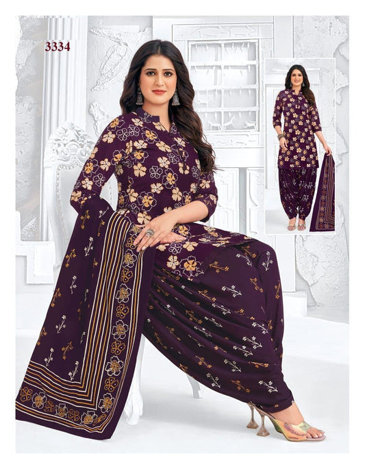 Woman wearing a purple floral outfit with matching pants, sitting on a white background.