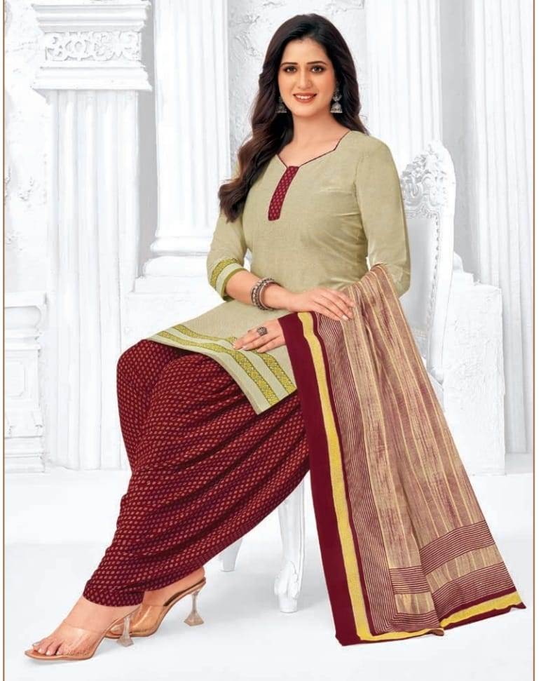 Woman wearing a traditional outfit with a green top and maroon patiala pants on a white background