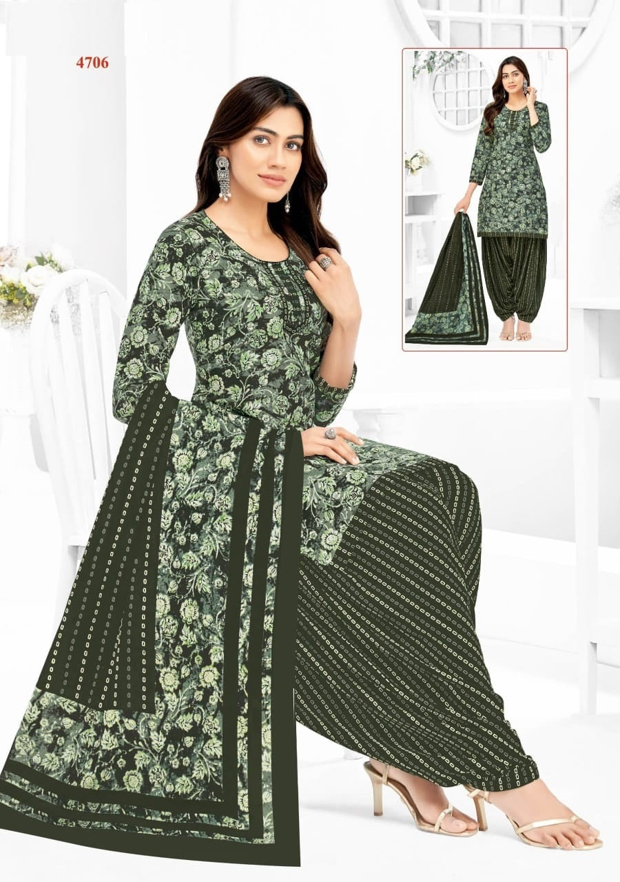 Woman wearing a green floral dress with matching dupatta on a white background