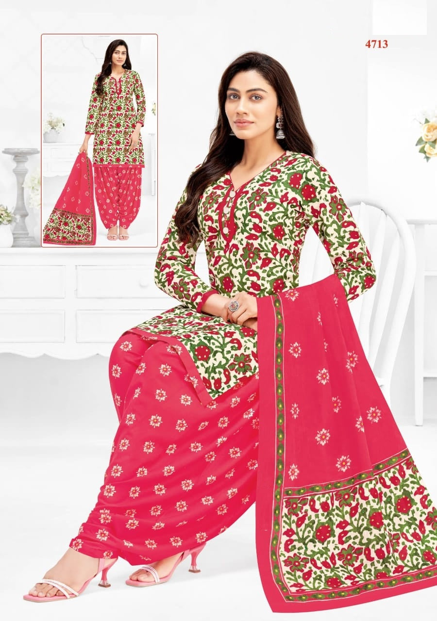 Woman wearing a pink and green traditional outfit with floral patterns on a white background