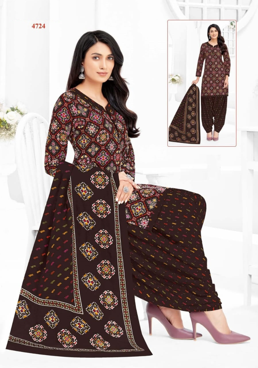 Woman wearing a brown patterned outfit with matching dupatta on a white background