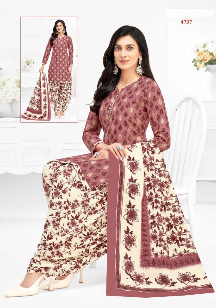 Woman wearing a maroon and beige patterned salwar kameez with a matching dupatta.