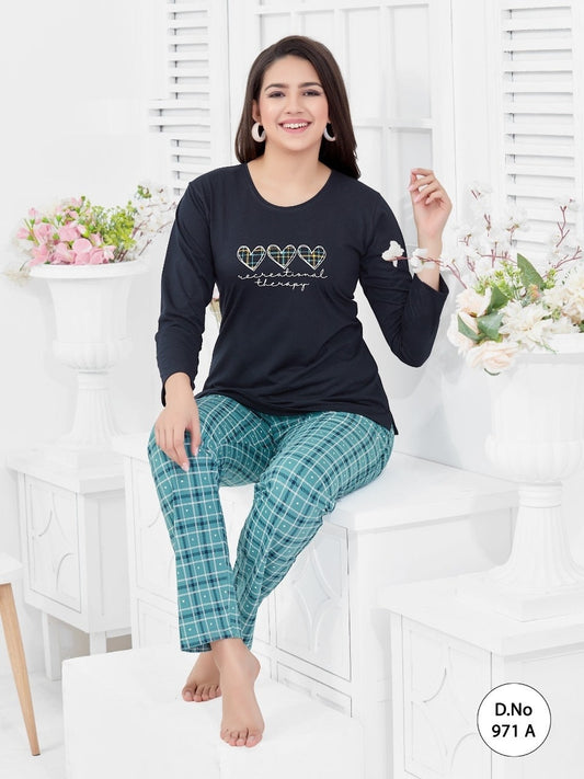 A woman sitting on a bench, wearing a black top with full sleeves and a round neckline, and green checkered bottoms.