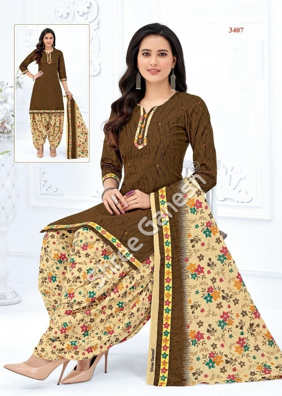 A woman sitting wearing a brown and floral cotton fully stitched suit with three-quarter sleeves and a dupatta.