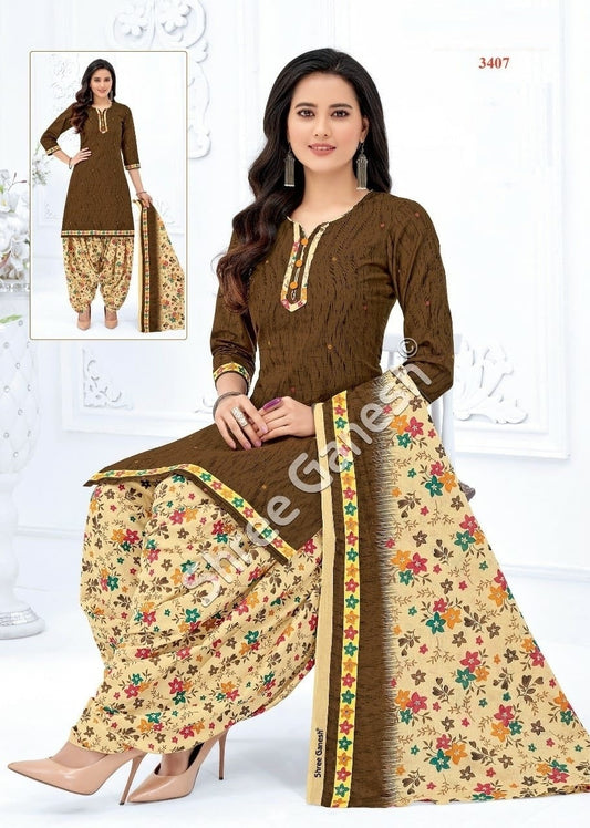 A woman sitting wearing a brown and floral cotton fully stitched suit with three-quarter sleeves and a dupatta.