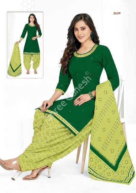 A woman wearing a green cotton suit with floral print, consisting of a top and bottom with matching dupatta (scarf).