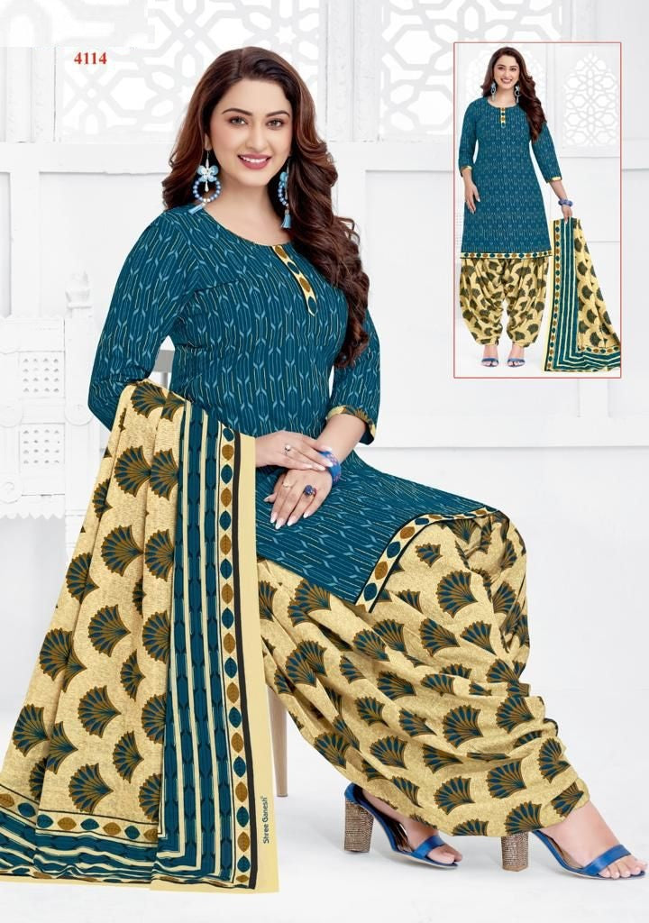 A woman wearing a fully stitched cotton suit with a printed design. The suit consists of a top and bottom with a dupatta.
