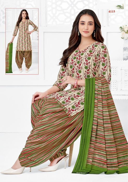 A woman wearing a fully stitched floral cotton suit with three-quarter sleeves and a long skirt with a green border.