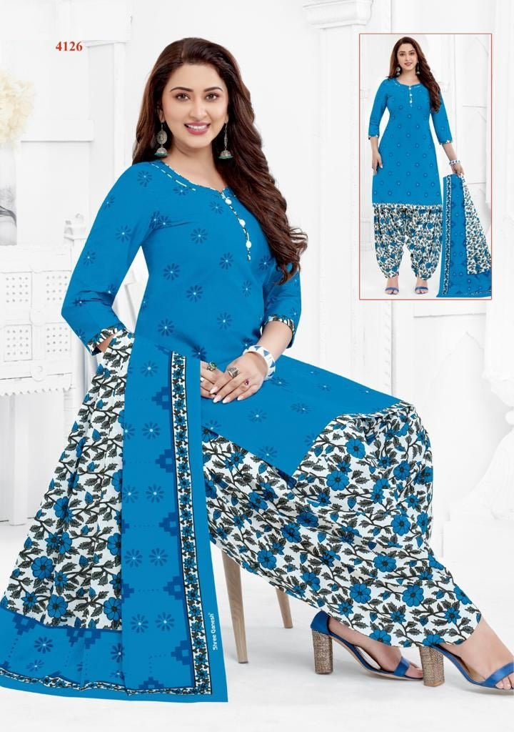 A woman wearing a blue and white printed cotton fully stitched suit with long sleeves and a matching dupatta.